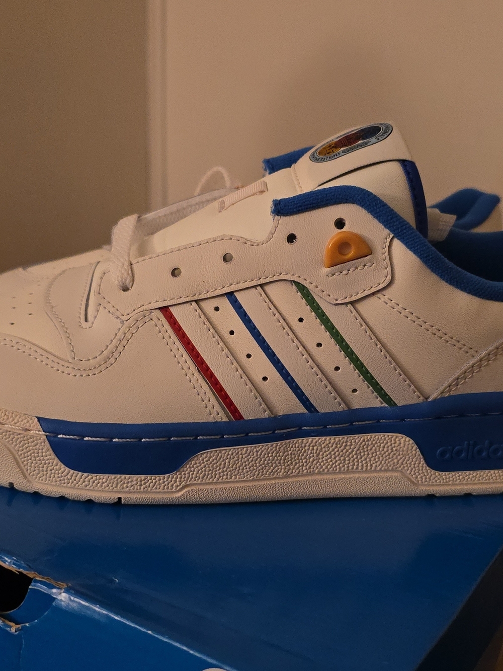 adidas White Sneakers with Blue Trim & Red/Blue/Green Stripe Accents